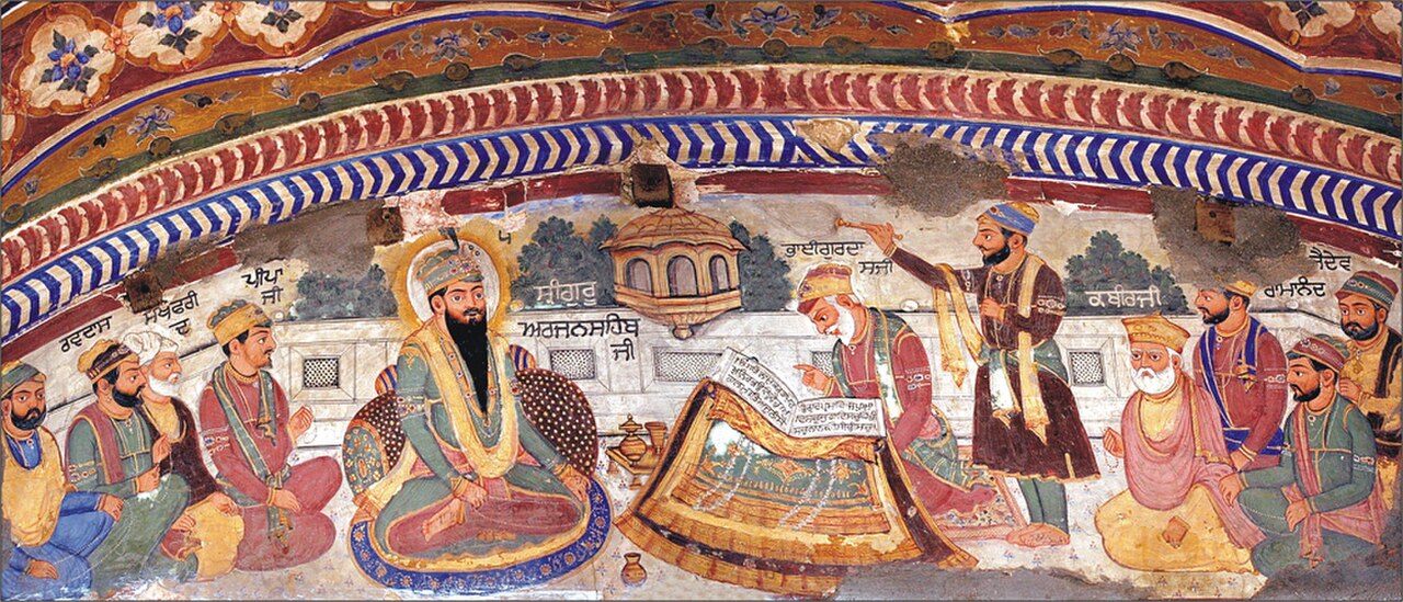 Painting of the contributors of the Guru Granth Sahib gathered around Guru Arjan as Bhai Gurdas writes the scripture