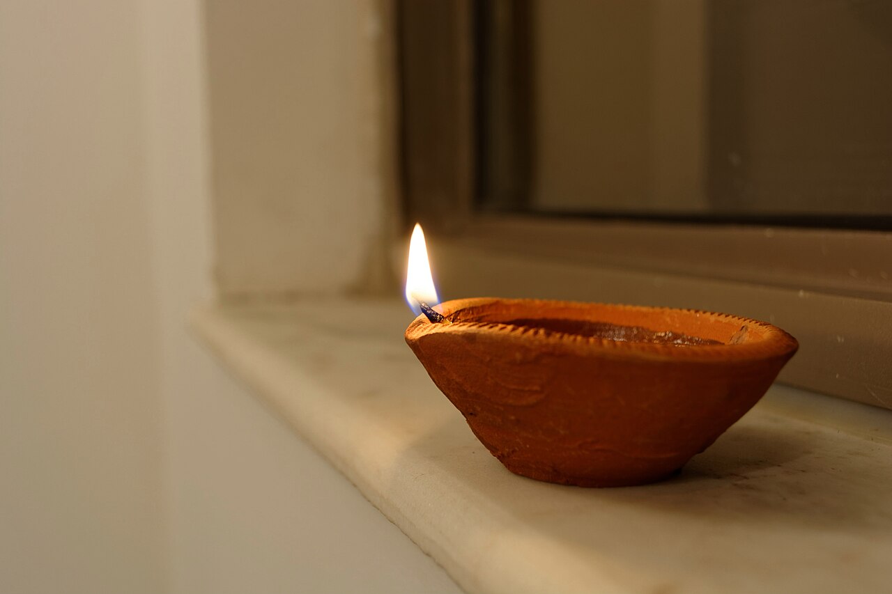 Brass thali with flowers, lamp, and offerings arranged for Hindu home worship